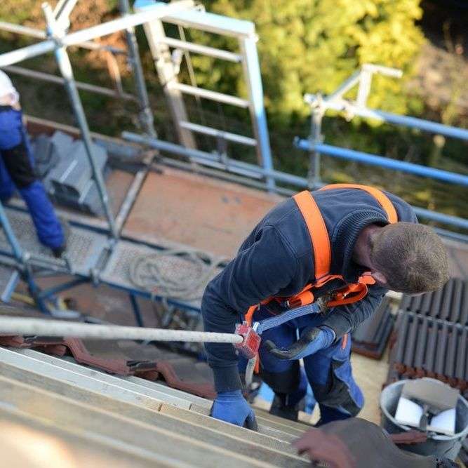 Dakdekker gezekerd en plaatsen van nieuwe dakpannen Dakdekker gezekerd en plaatsen van nieuwe dakpannen